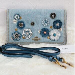 Coach Blue Crossbody Bag with Floral Embellishments and Elegant Strap